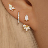 Magda – Delicate gold earrings with a soft shimmer.
