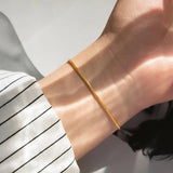 Carina – Gold bracelet with polished platinum finish.