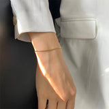 Carina – Gold bracelet with polished platinum finish.