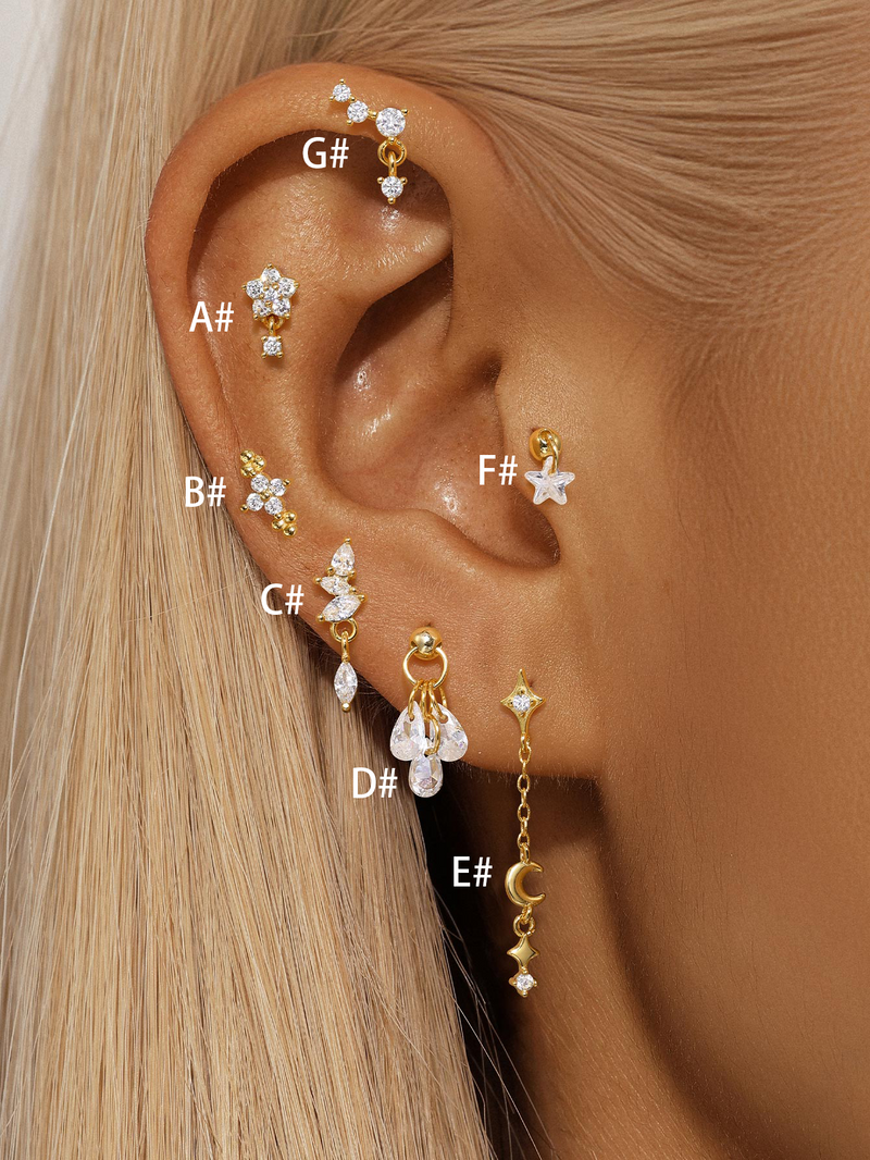 Lina – Golden earrings with delicate filigree curvature.