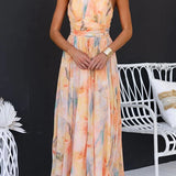 Maxi dress with halter neck and open back, fitted waist, watercolor print
