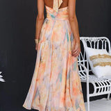 Maxi dress with halter neck and open back, fitted waist, watercolor print
