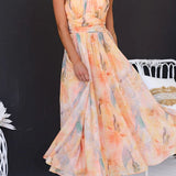 Maxi dress with halter neck and open back, fitted waist, watercolor print