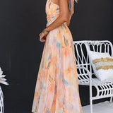 Maxi dress with halter neck and open back, fitted waist, watercolor print