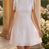 Embroidered short dress with bows