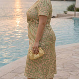 Mid-length dress with a slimming effect, central knot, and fluid drape
