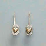 Vintage earrings with a heart embedded in gold.