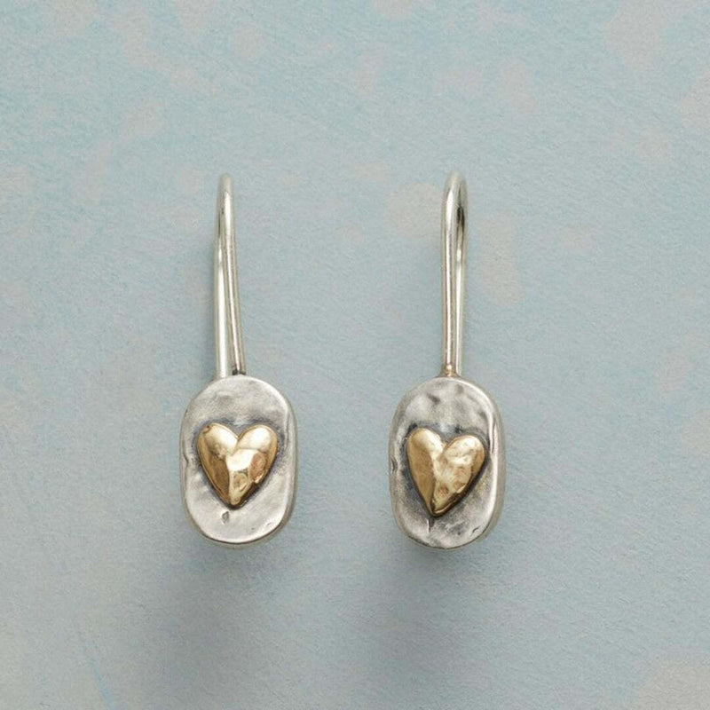 Vintage earrings with a heart embedded in gold.
