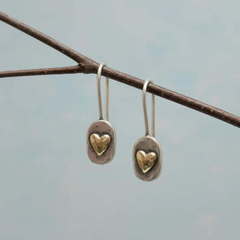 Vintage earrings with a heart embedded in gold.