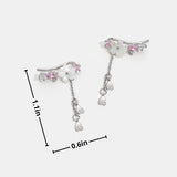 Maren – Gold earrings with dangling pearls.