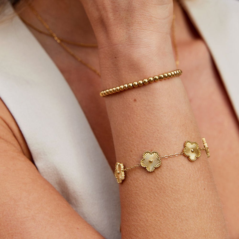 "Lucky Gold Bracelet" can be rewritten as "Gold Bracelet of Luck".