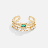 Sabina – Golden ring with emerald green details.