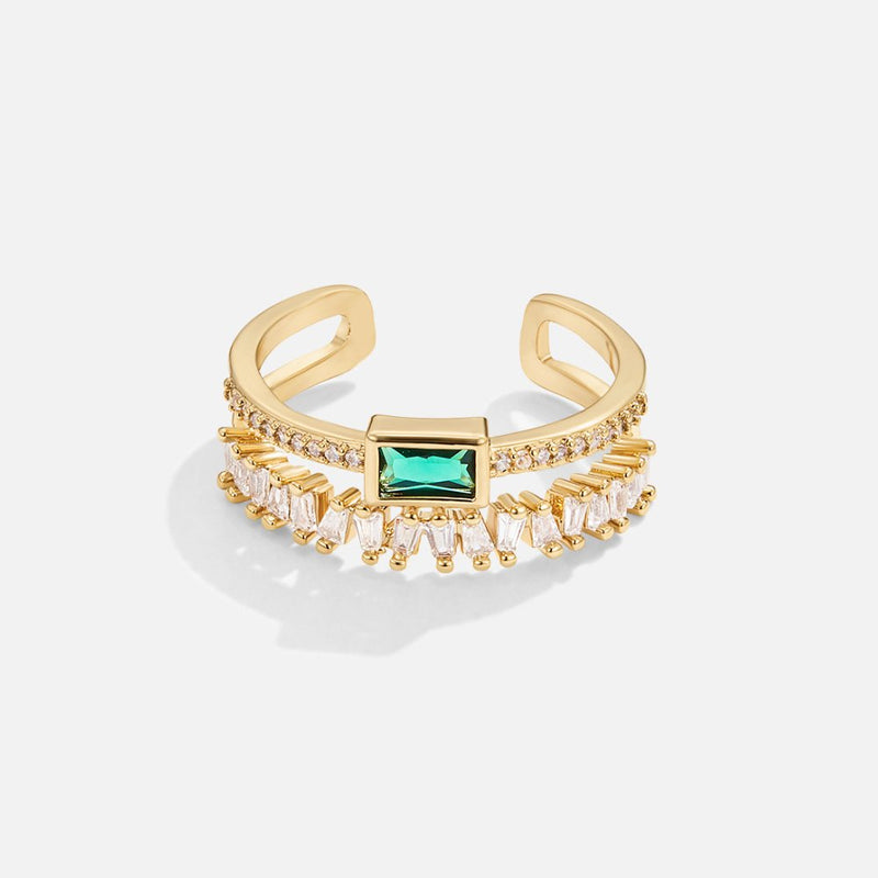 Sabina – Golden ring with emerald green details.