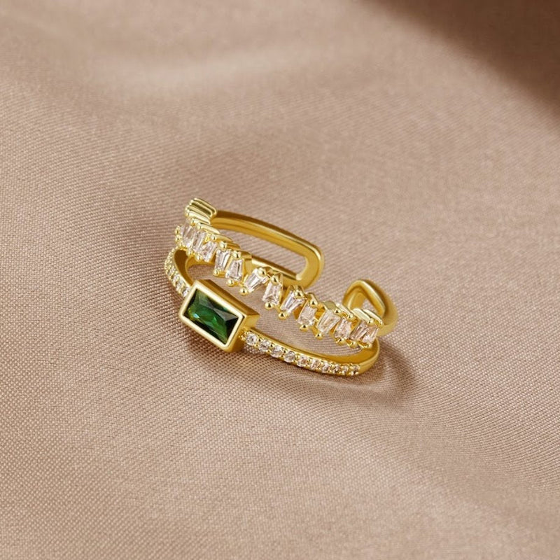 Sabina – Golden ring with emerald green details.