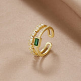 Sabina – Golden ring with emerald green details.