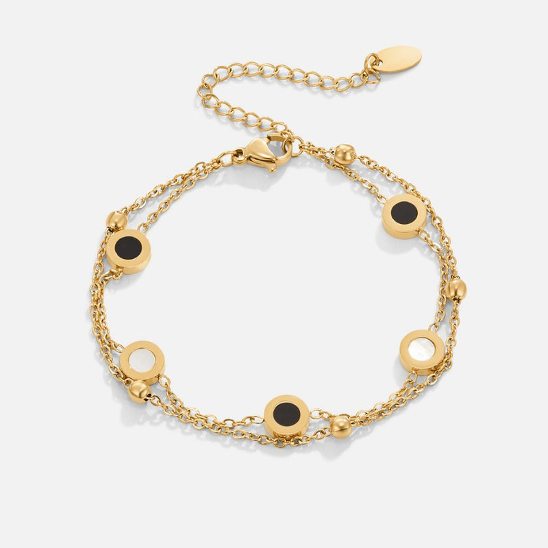 Carla – Elegant gold bracelet with contrasting round details.