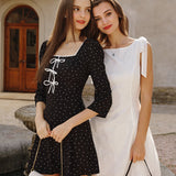Embroidered short dress with bows